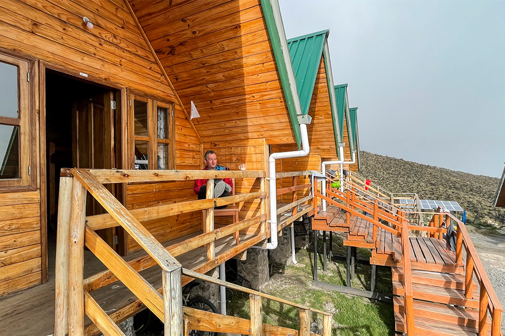 Climber resting at Mandara Hut on Marangu Route