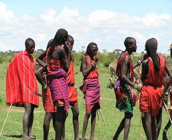 Tourist experiencing Maasai manyatta traditional hut entrance